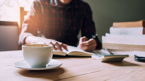 Woman sitting on table at cafe