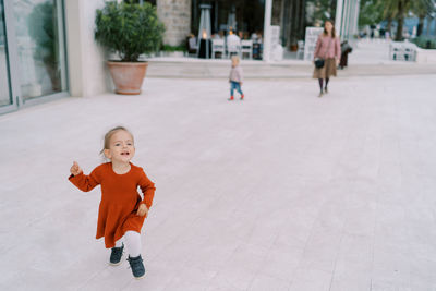 Portrait of cute girl standing on street