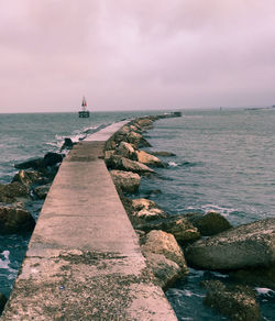 Scenic view of sea against cloudy sky