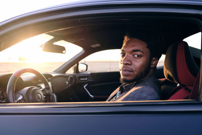 Portrait of man sitting in car