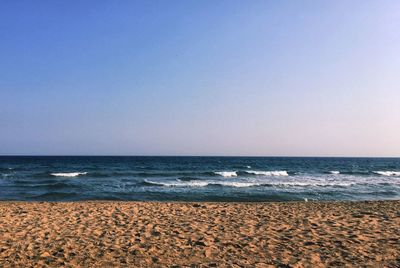 Scenic view of beach against clear sky