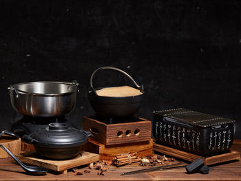 Close-up of old tea cup on table against black background