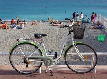 View of bicycle against people on beach