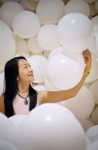 High angle view of woman looking at balloons