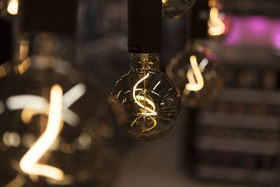 Light bulbs hanging from ceiling, abstract image with bokeh background