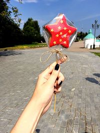 Cropped hand holding candy