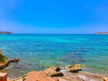 Scenic view of sea against clear blue sky