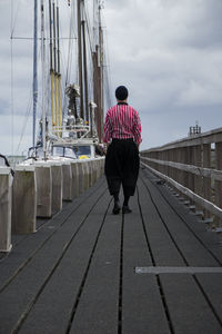 Rear view of man on sailboat