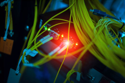 Close-up of yellow cables attached to electrical equipment