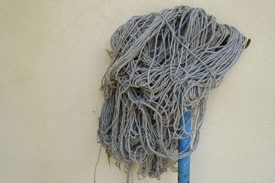 Close-up of mop against wall