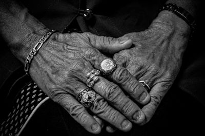 Close-up of senior woman showing rings