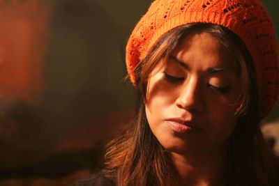 Close-up portrait of young woman with eyes closed