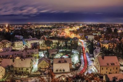 Illuminated cityscape against sky at night