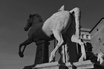 Low angle view of statue against sky