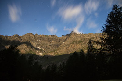 Low angle view of mountains against sky at night