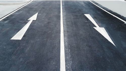 High angle view of arrow sign on road