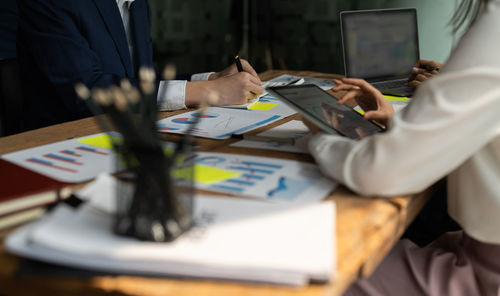 Midsection of business colleagues working at office