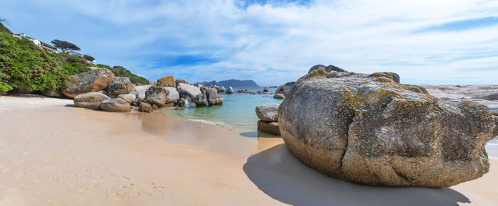 Panoramic view of rocks on beach against sky . boulders beach , cape town , south africa