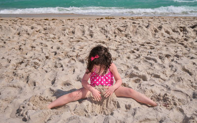 Cute young girl playing and fooling around at the beach