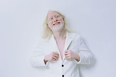 Young woman with stethoscope against white background