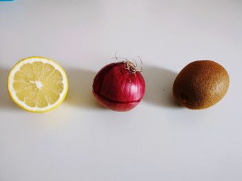 Close-up of fruits on table against white background