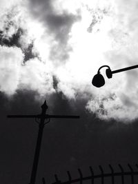 Low angle view of street light against cloudy sky