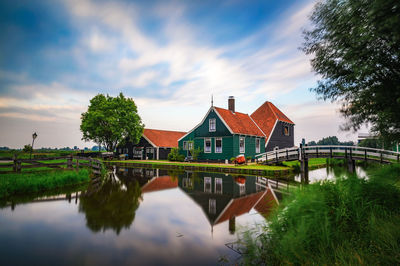 Scenic view of lake by buildings against sky