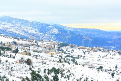 Scenic view of snow covered mountains against sky