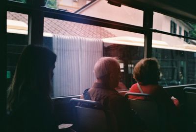 Rear view of people sitting in bus