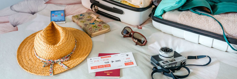 Unrecognizable woman preparing suitcase for summer holidays