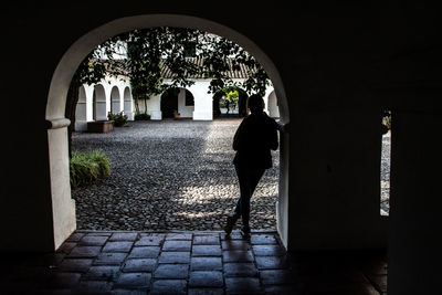 Rear view of silhouette woman walking in building