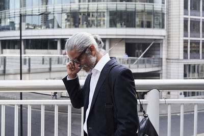 Grey-haired senior businessman talking on the phone