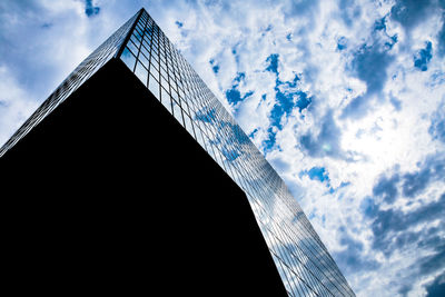 Low angle view of building against cloudy sky