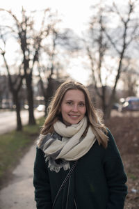 Portrait of smiling woman standing in snow