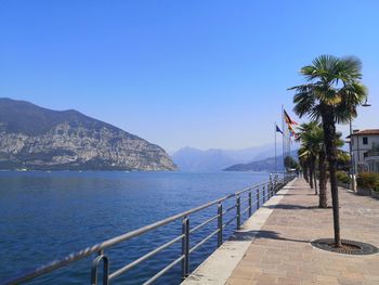 Scenic view of sea against clear blue sky near a lake.