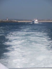 Boat sailing in sea against sky