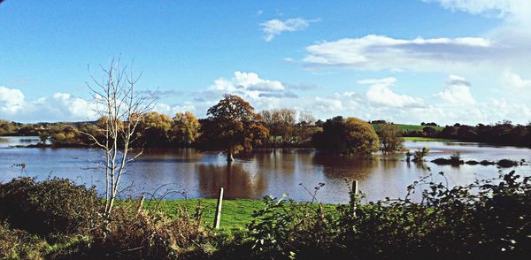 Scenic view of lake against cloudy sky