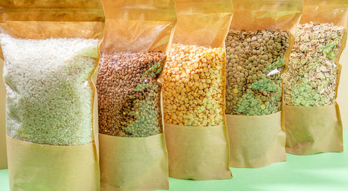 Paper bags with cellophane full of cereals and legumes close-up. zero waste. no plastic.
