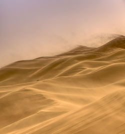 Scenic view of desert against sky during sunset