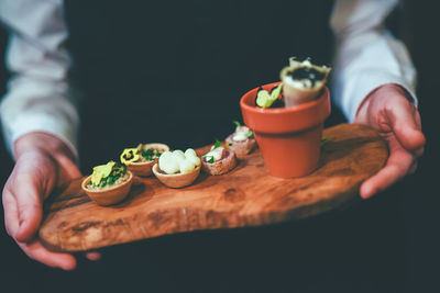 Midsection of waiter holding food