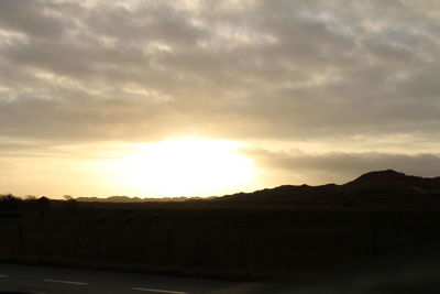 Scenic view of landscape against sky during sunset