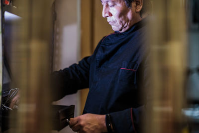 Close-up of chef working at kitchen