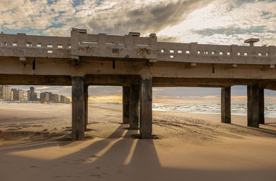 Bridge at sea against sky