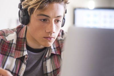 Boy using laptop on table