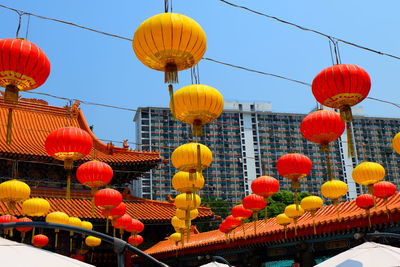 Low angle view of lanterns hanging against sky