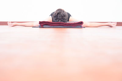 Woman exercising against white background