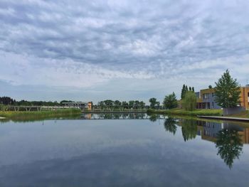 Scenic view of lake against cloudy sky