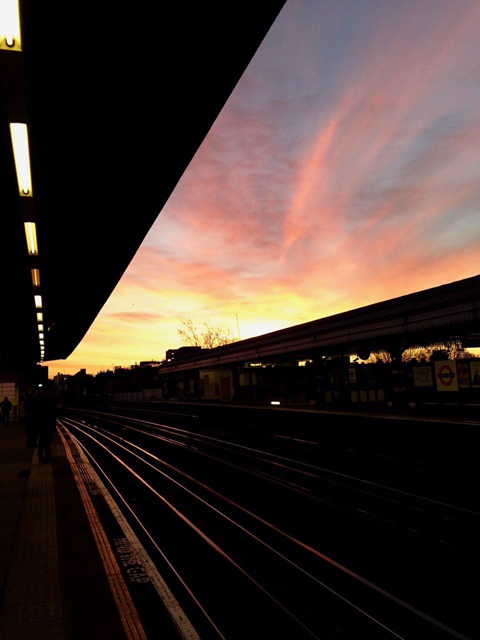 RAILWAY STATION AGAINST SKY AT SUNSET