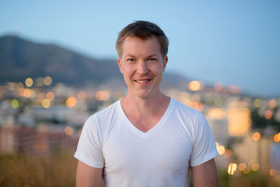 Portrait of smiling man standing outdoors