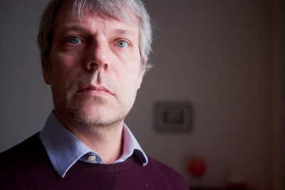 Close-up of man looking away at home